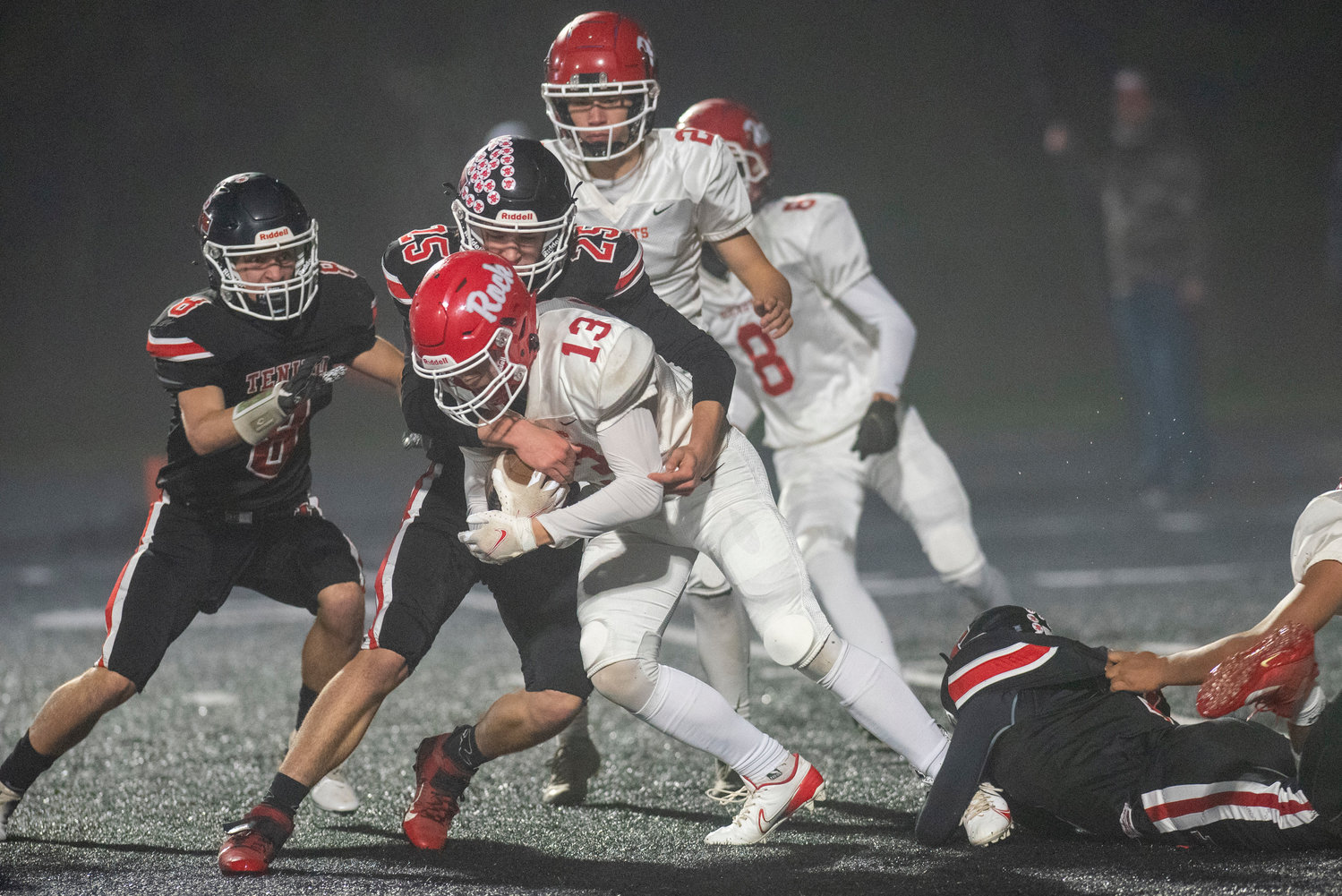 Tenino's Brody Noonan (25) tackles Castle Rock's Hayden Curtiss (13) during a district playoff game Friday, Nov. 5.