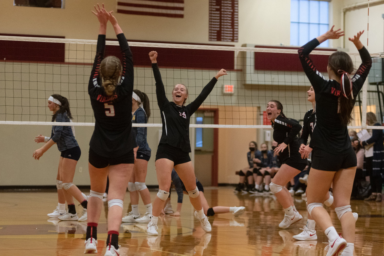 The Mossyrock volleyball team celebrates a block against Naselle in the 1B District 4 title game in Winlock Nov. 6.