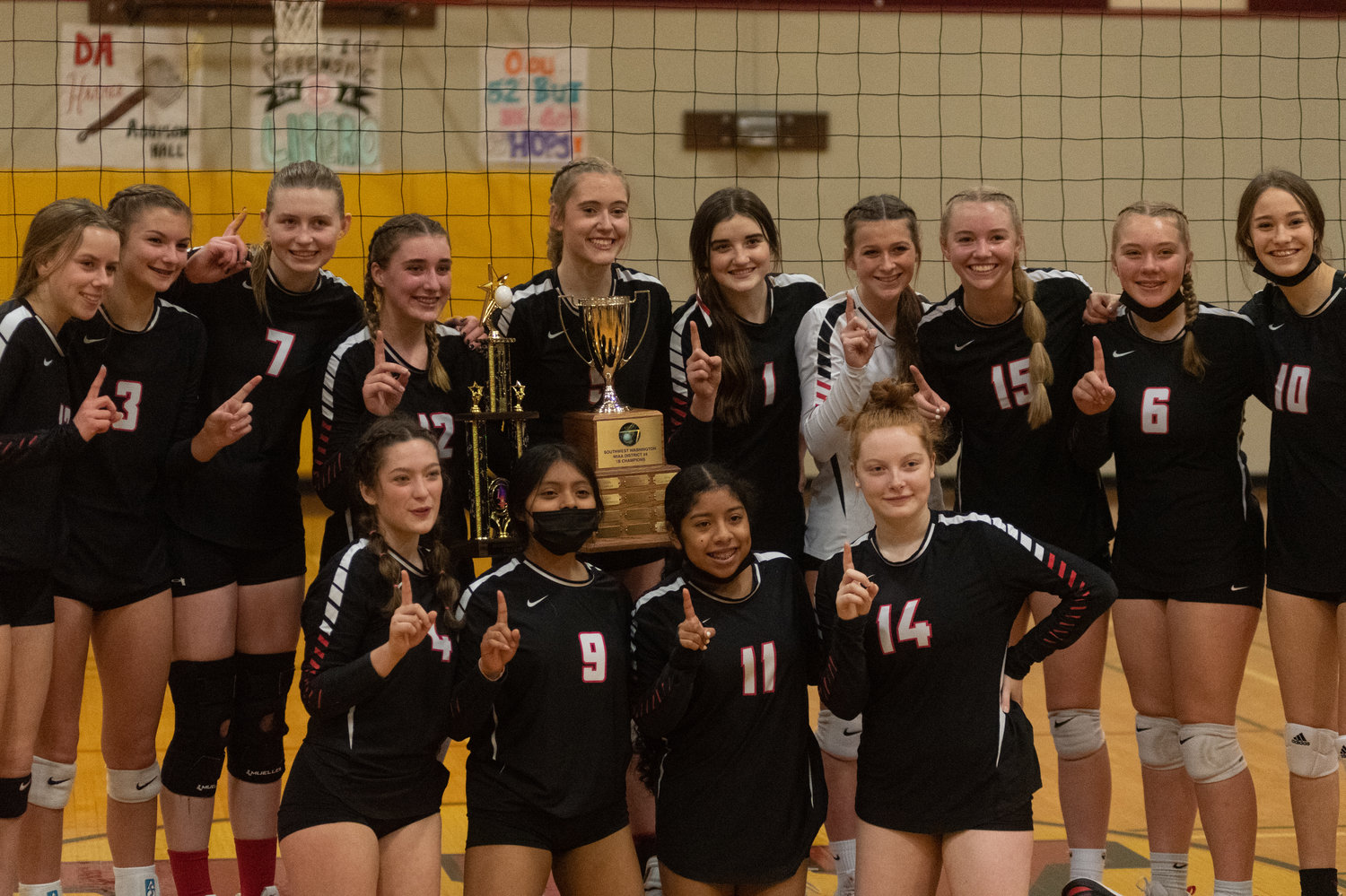 The Mossyrock volleyball team poses for a photo with the 1B District 4 trophy after beating Naselle in Winlock Nov. 6.