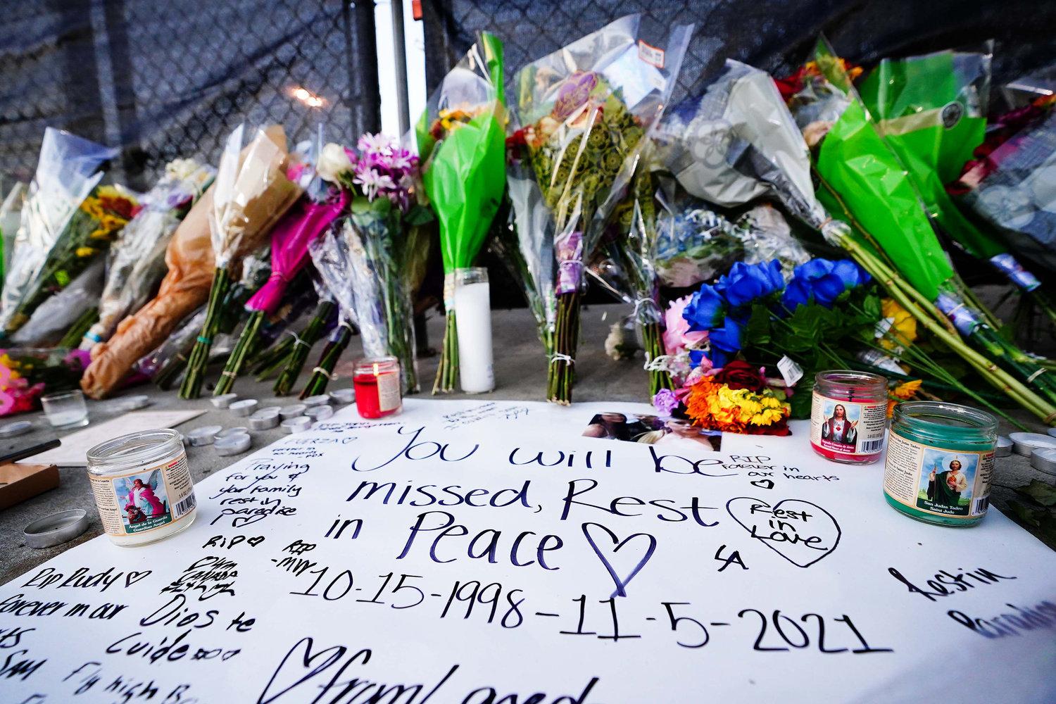 Candles, flowers and letters are placed at a memorial outside of the canceled Astroworld festival at NRG Park on Nov. 7, 2021, in Houston. According to authorities, eight people died and 17 people were transported to local hospitals after what was described as a crowd surge at the Astroworld festival, a music festival started by Houston-native rapper and musician Travis Scott in 2018. (Alex Bierens de Haan/Getty Images/TNS)