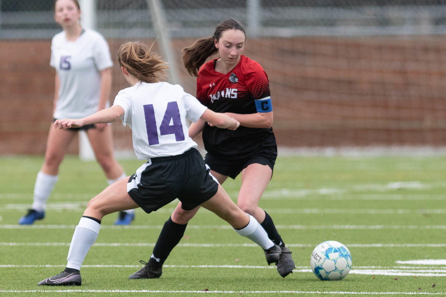 Rose Dillon fights past a Friday Harbor defender in the opening round of the WIAA 2B soccer tournament in Black Hills Nov. 10.