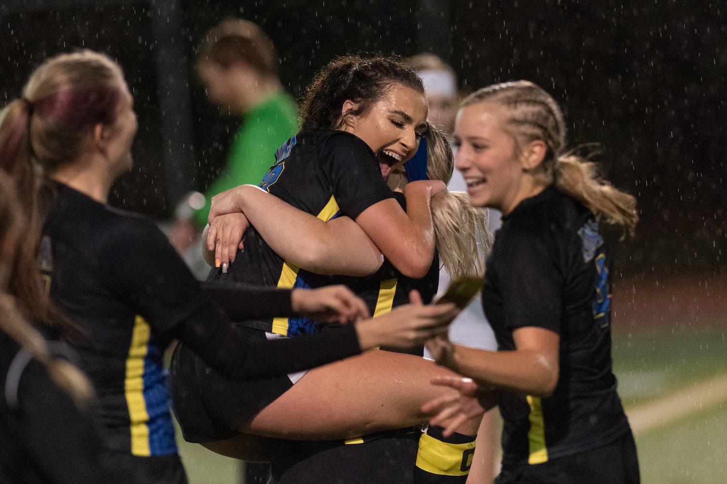 Adna seniors Presley Smith and Sadie Burdick embrace after the Pirates opening round victory against Cle Elum-Roslyn in the state tournament in Tumwater Nov. 10.