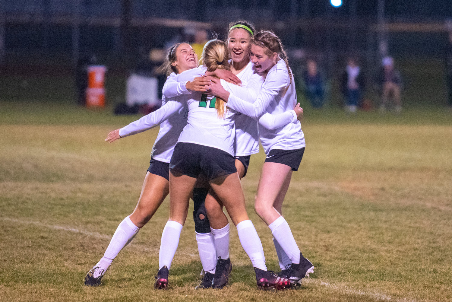 Tumwater players hug Ainsley Wall (12) after Wall scores the first goal of the night against Selah on Wednesday.
