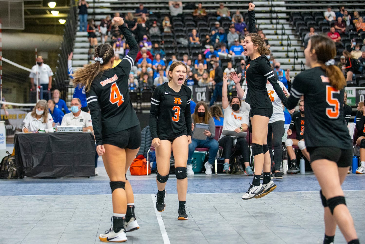 Rainier players celebrate after scoring against La Conner in the first round of the state tournament Thursday in Yakima.