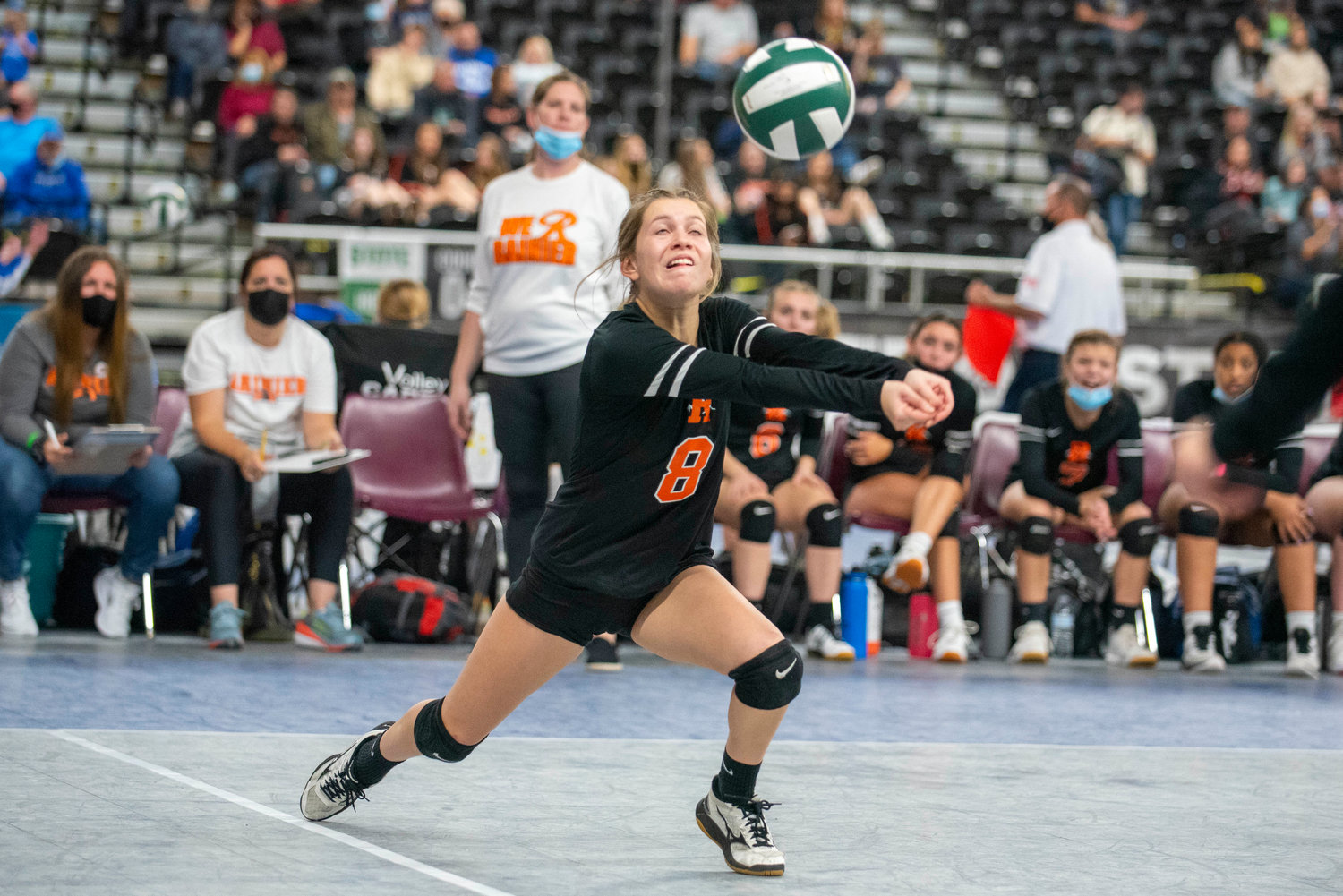 Rainier’s Olivia Earsley hustles for a La Conner spike during the state tournament Thursday in Yakima.