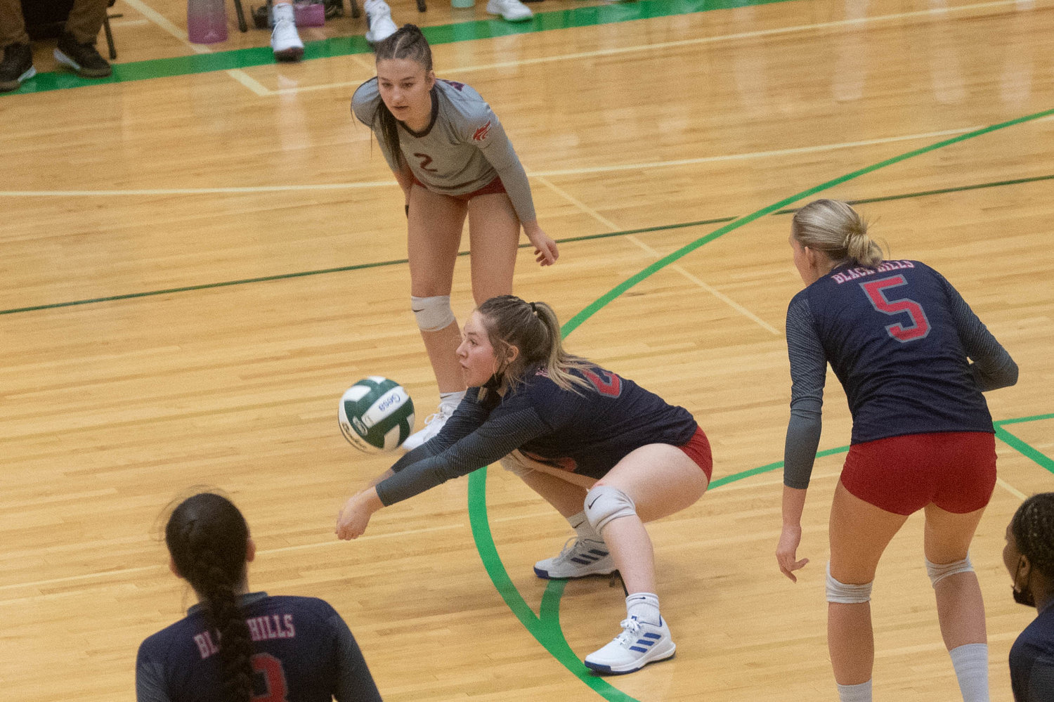 Black Hills junior Charlotte Michaud digs up a serve against R.A. Long in the opening round of the 2A District 4 tournament in Tumwater Nov. 11.