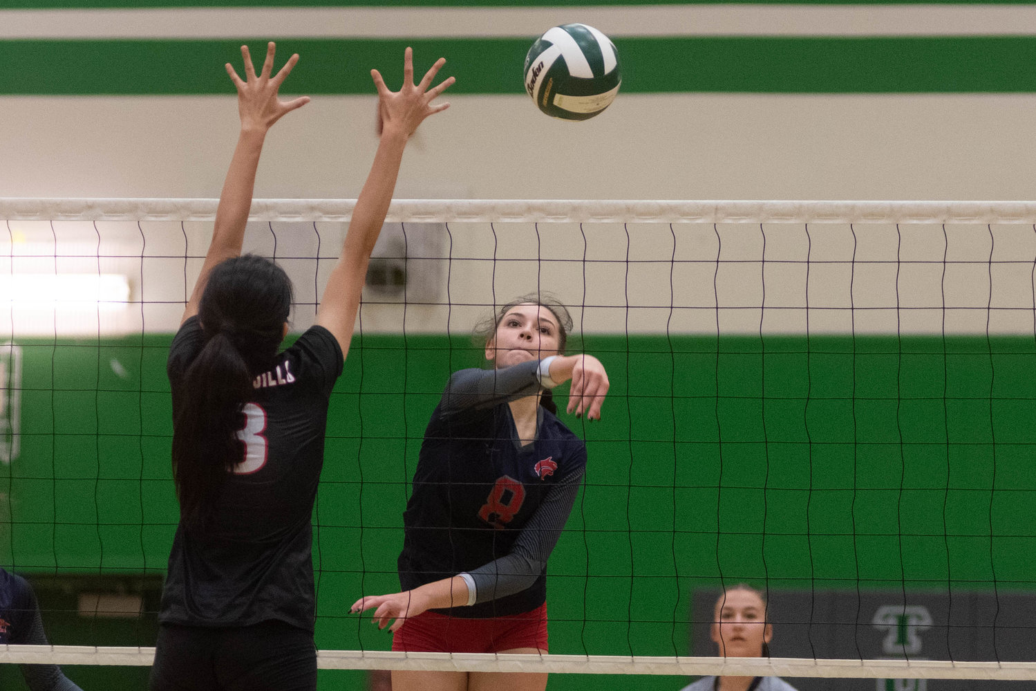 Black Hills middle Payton Childers sends a shot over the net against R.A. Long in the opening round of the 2A District 4 tournament in Tumwater Nov. 11.
