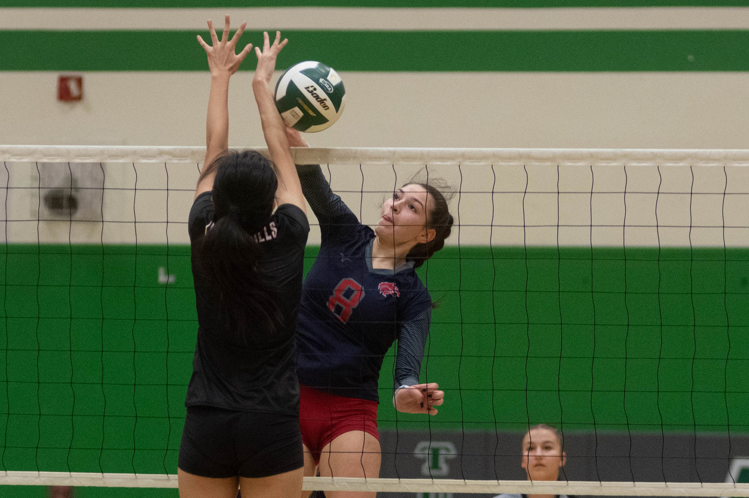 Black Hills middle Payton Childers spikes a ball over the net against R.A. Long in the opening round of the 2A District 4 tournament in Tumwater Nov. 11.