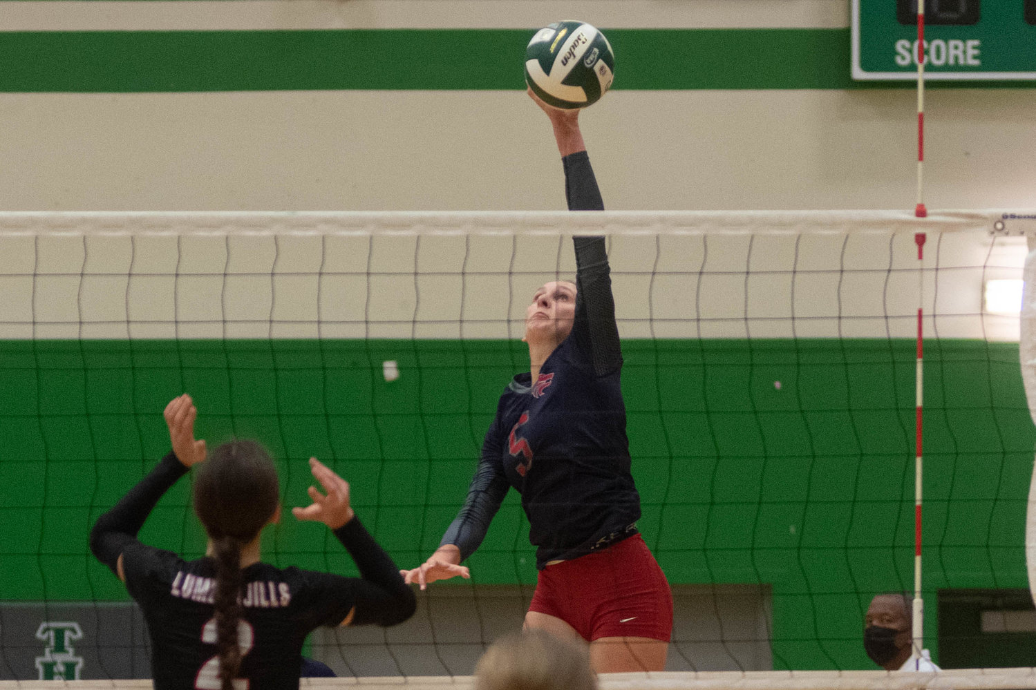 Black Hills senior Olivia Hisaw sends a spike over the net against R.A. Long in the opening round of the 2A District 4 tournament in Tumwater Nov. 11.
