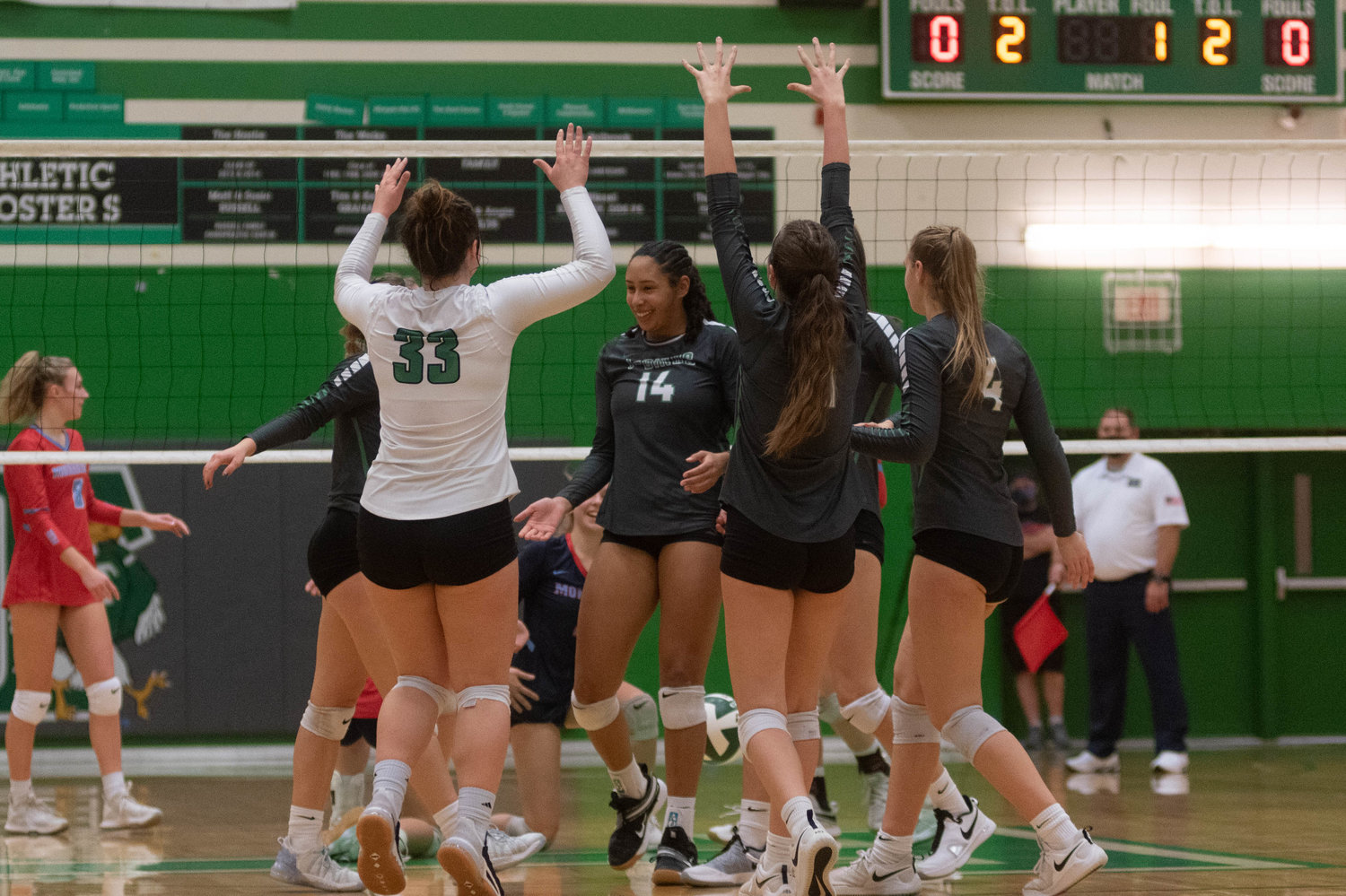 The Tumwater volleyball team celebrates a point against Mark Morris in the opening round of the 2A District 4 tournament Nov. 11.