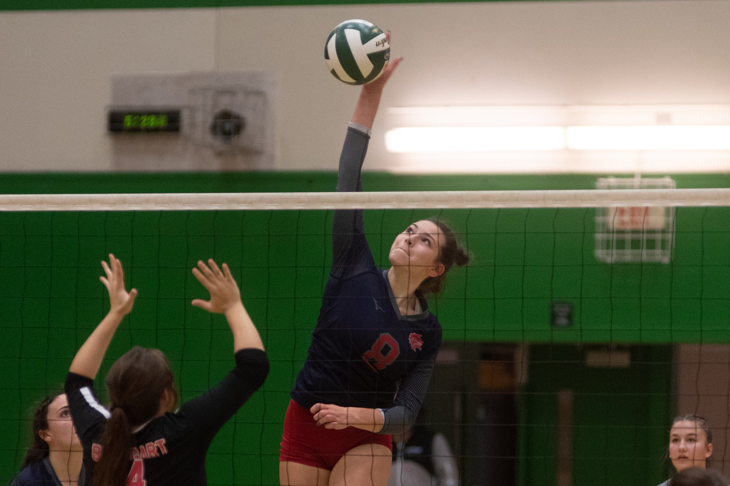 Black Hills middle Payton Childers sends a ball across the net against Shelton in a consolation matchup in the 2A District 4 tournament in Tumwater Nov. 11.