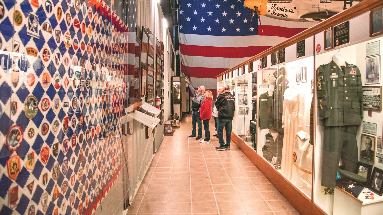 Visitors at the Veterans Memorial Museum point to photos and relics on display Thursday on Veterans Day in Chehalis.