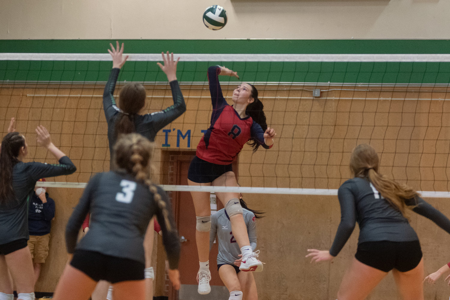Black Hills middle Payton Childers sends a ball over the net against Tumwater in the district playoffs Nov. 13.
