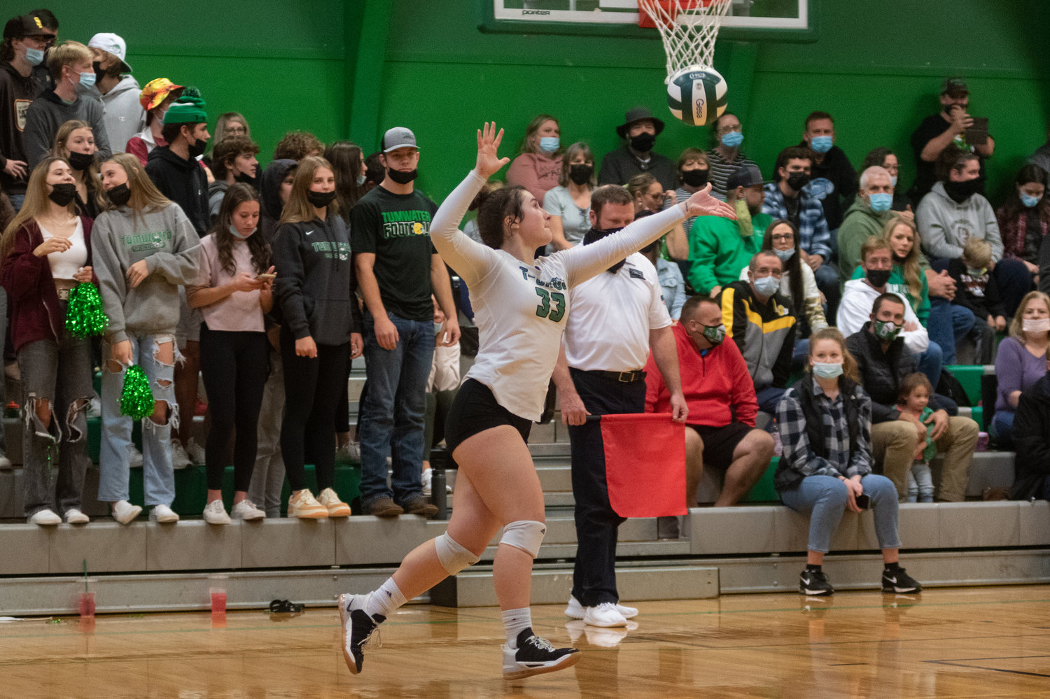 Tumwater's libero goes up to serve in front of a home crowd against Black Hills in the district playoffs Nov. 13.