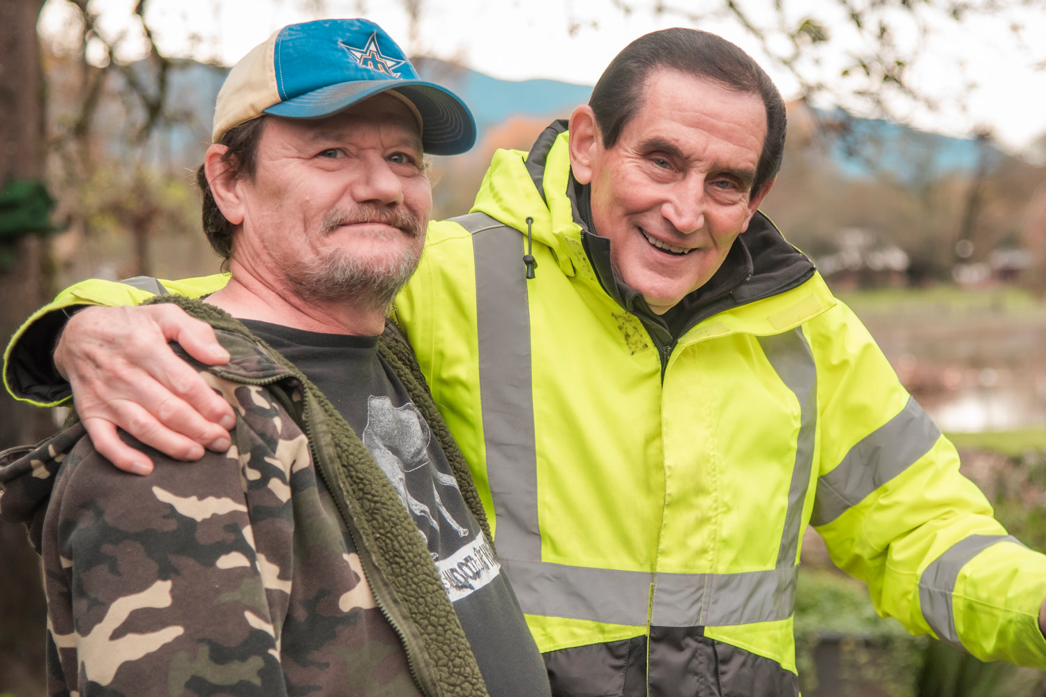 William Calkin, left, poses for a photo with Howard Justice, 85, of Randle while checking on his neighbor as floodwaters recede on Saturday.