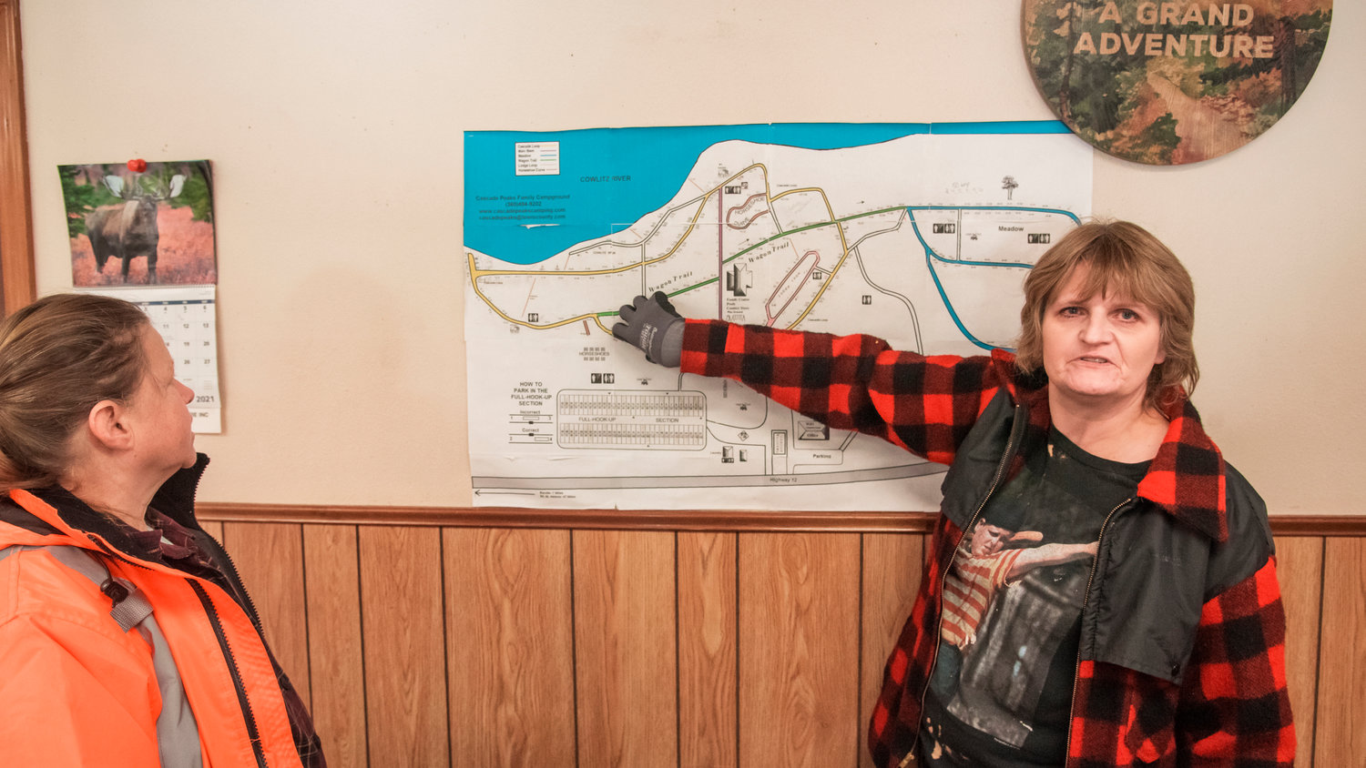 Laurie Shephard, who does maintenance, points to an area on a map of the Cascade Peak Campground in Randle affected by flooding.