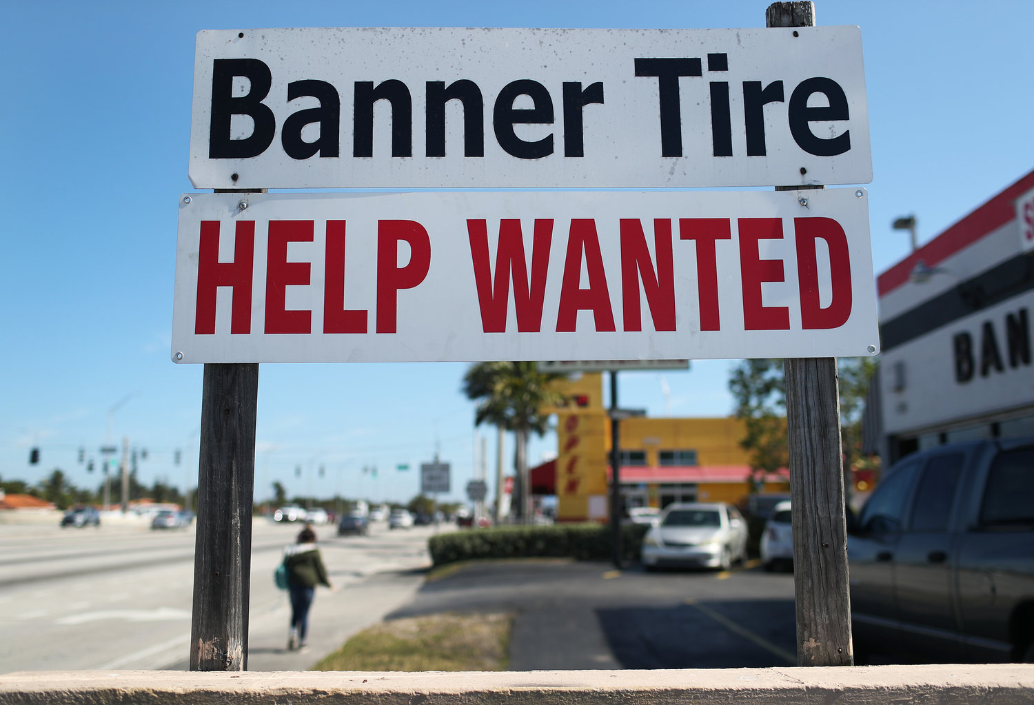 A "Help Wanted" sign is posted in front of a business on February 4, 2021 in Miami. (Joe Raedle/Getty Images/TNS)