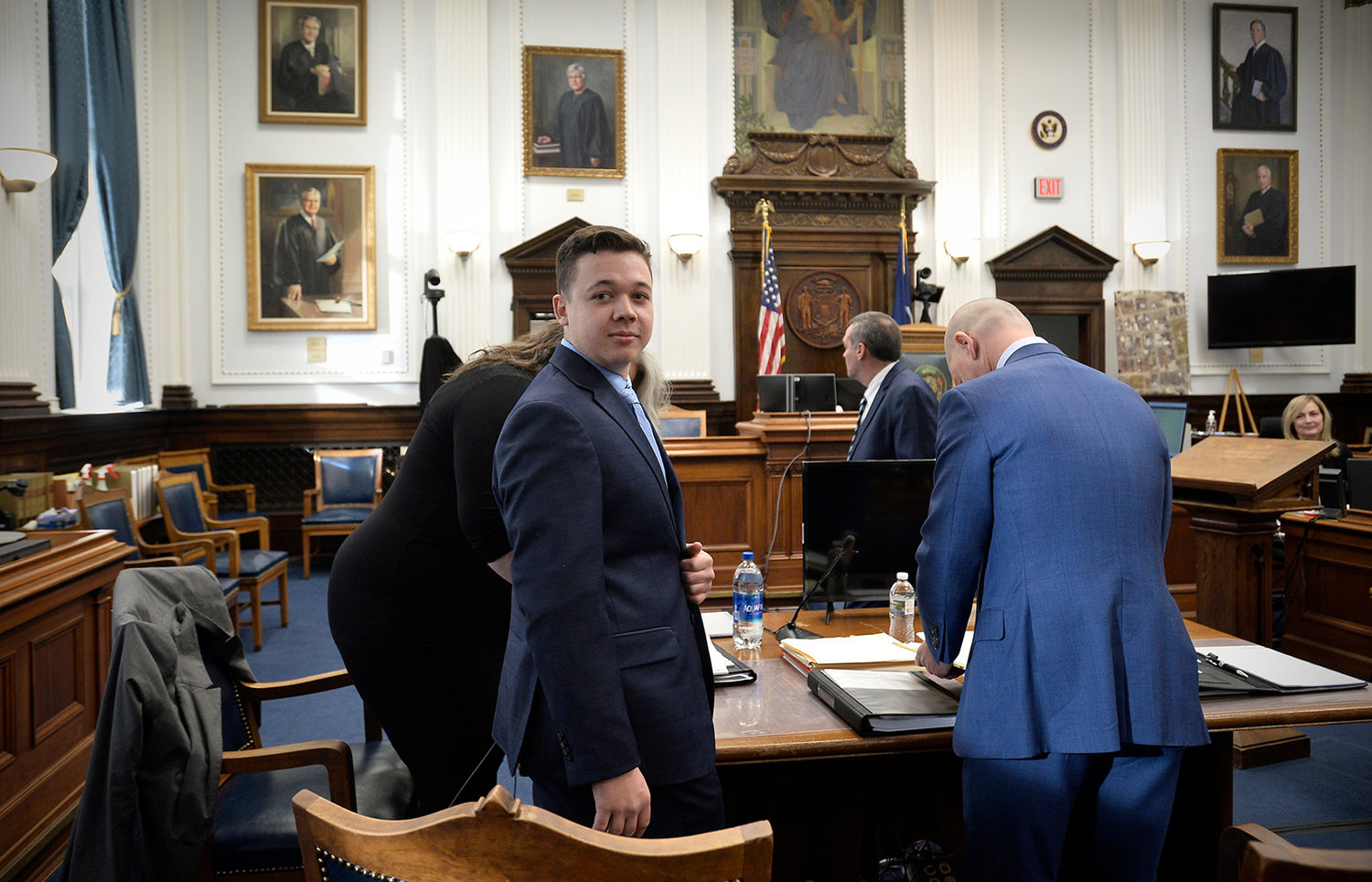Kyle Rittenhouse, center, makes his way to his seat at the beginning of the day at the Kenosha County Courthouse on Nov. 15, 2021, in Kenosha, Wisconsin. (Sean Krajacic/Pool/Getty Images/TNS)