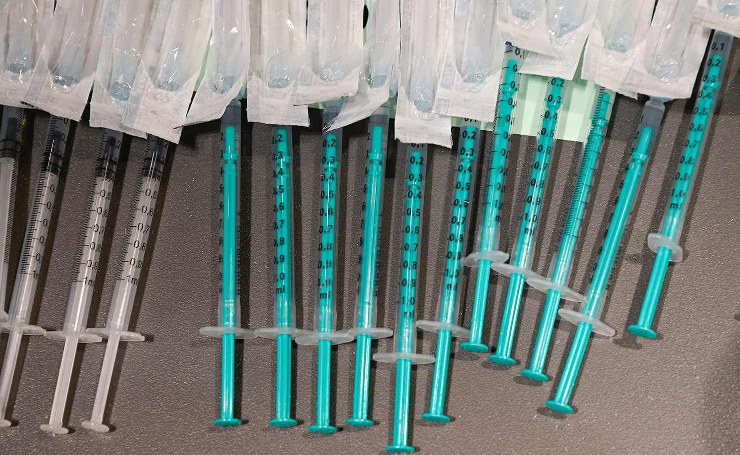 Syringes filled with the Pfizer Biontech Covid-19 vaccine lie on a tray in a mobile Covid-19 vaccination centre set up in a shopping mall in Ludwigsburg, southern Germany, on Nov. 11, 2021, amid a surge of infections during the ongoing coronavirus pandemic. (Thomas Kienzle/AFP via Getty Images/TNS)