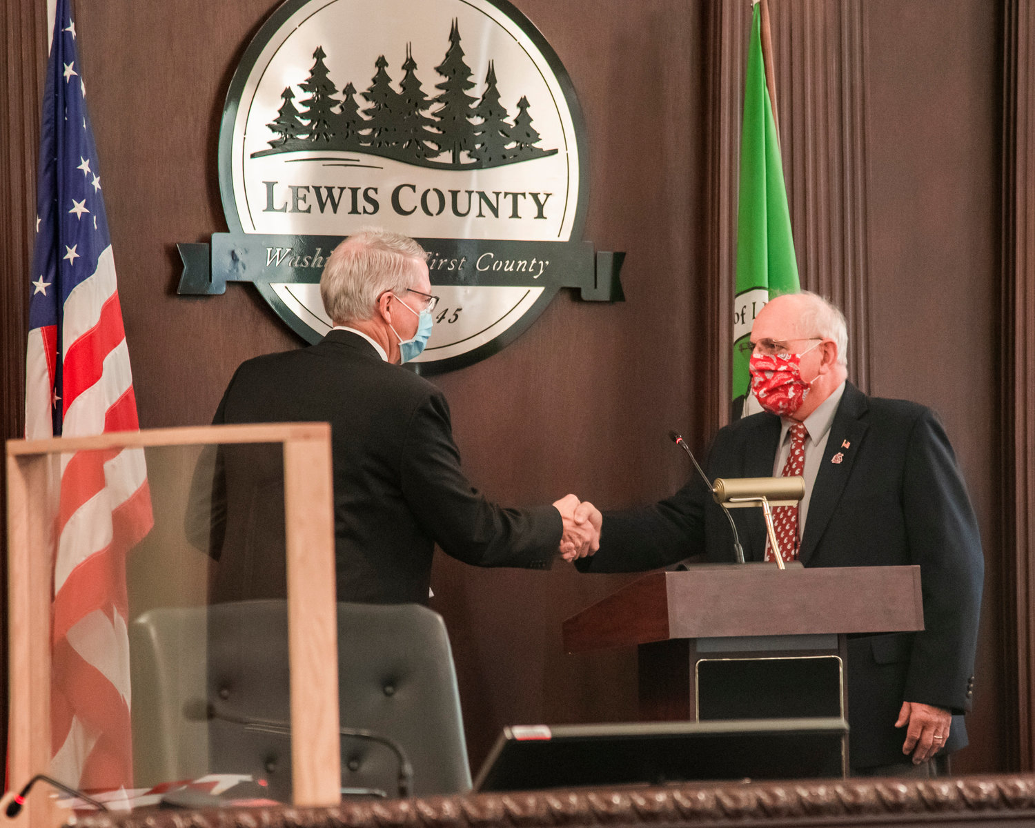 Judge James Lawler shakes hands with Commissioner Lee Grose Wednesday morning at the Historic Lewis County Courthouse in Chehalis.