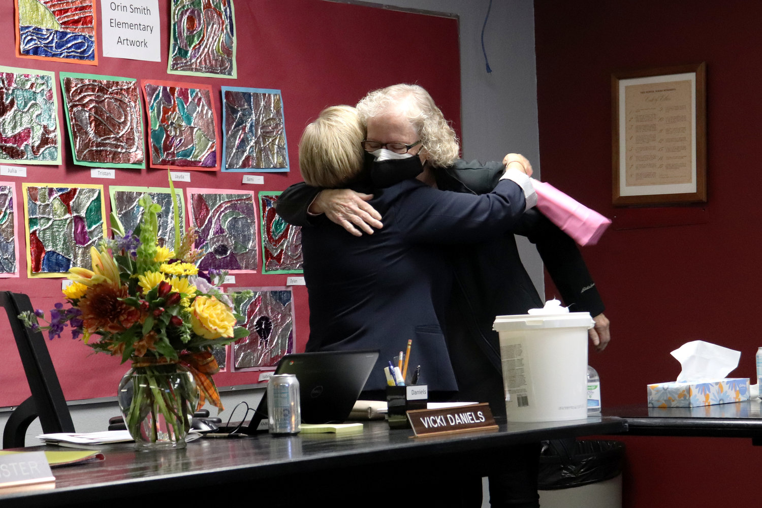 Fellow Chehalis School Board members Vicki Daniels and Colleen State hug at Daniels’ final school board meeting as Director of District 3 on Tuesday.