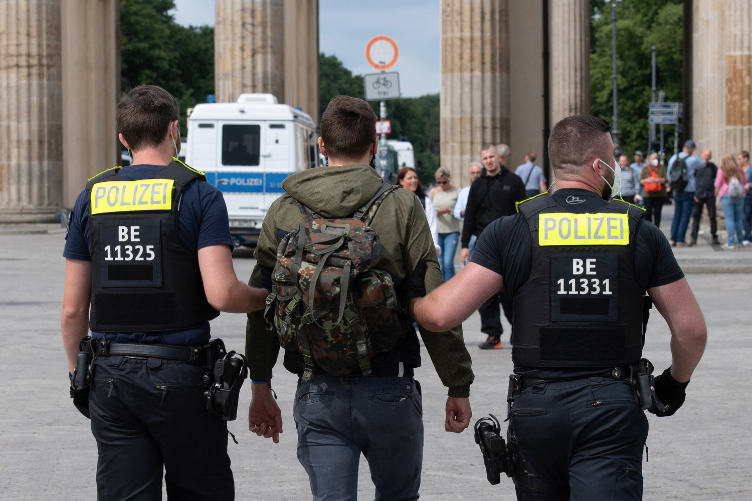 German police arrest a participant of an anti-lockdown protest in front of the Brandenburg Gate in Berlin on August 1, 2021. Berlin police clashed with COVID-19 skeptics after hundreds of them took to the streets despite a court-ordered protest ban. (Paul Zinken/AFP/Getty Images/TNS)