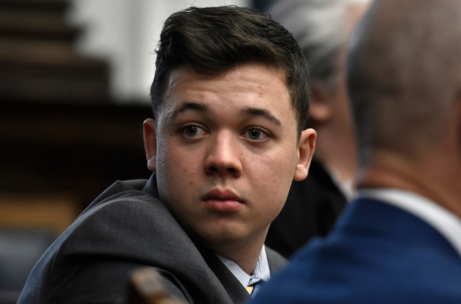 Kyle Rittenhouse looks back as attorneys discuss items in the motion for mistrial presented by his defense during his trial at the Kenosha County Courthouse on Nov. 17, 2021 in Kenosha, Wisconsin. (Sean Krajacic/Pool/Getty Images)
