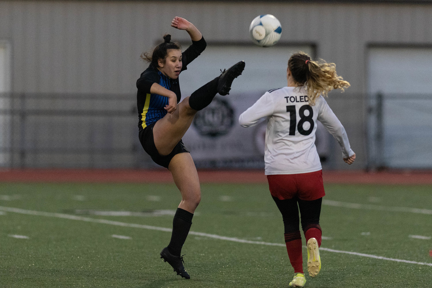 An Adna player kicks a ball in midair against Toledo in the 2B state semifinals Nov. 19.