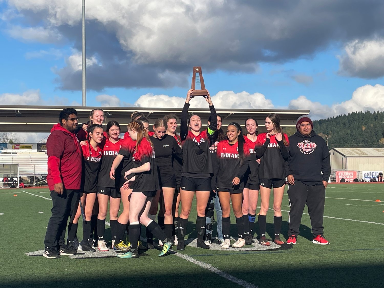 The Toledo girls soccer poses with the fourth-place trophy after the 2B state tournament at Sunset Stadium Nov. 20. It's Toledo's first state trophy in program history.