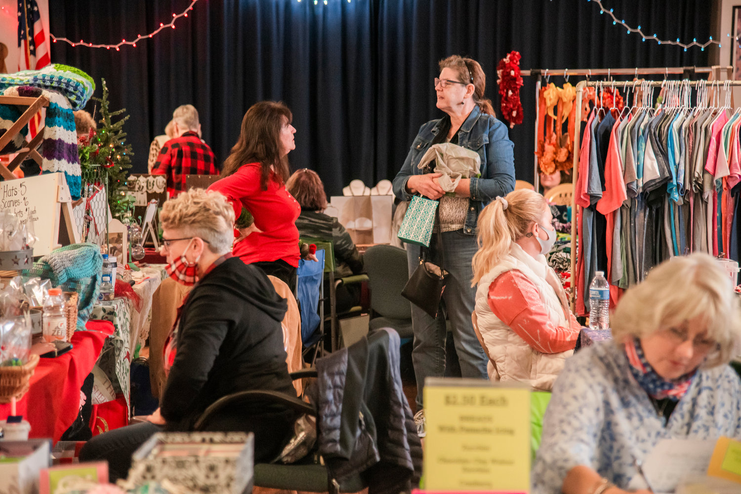 Attendees of a Fall Bazaar mingle around tables and display racks Saturday afternoon in Adna.