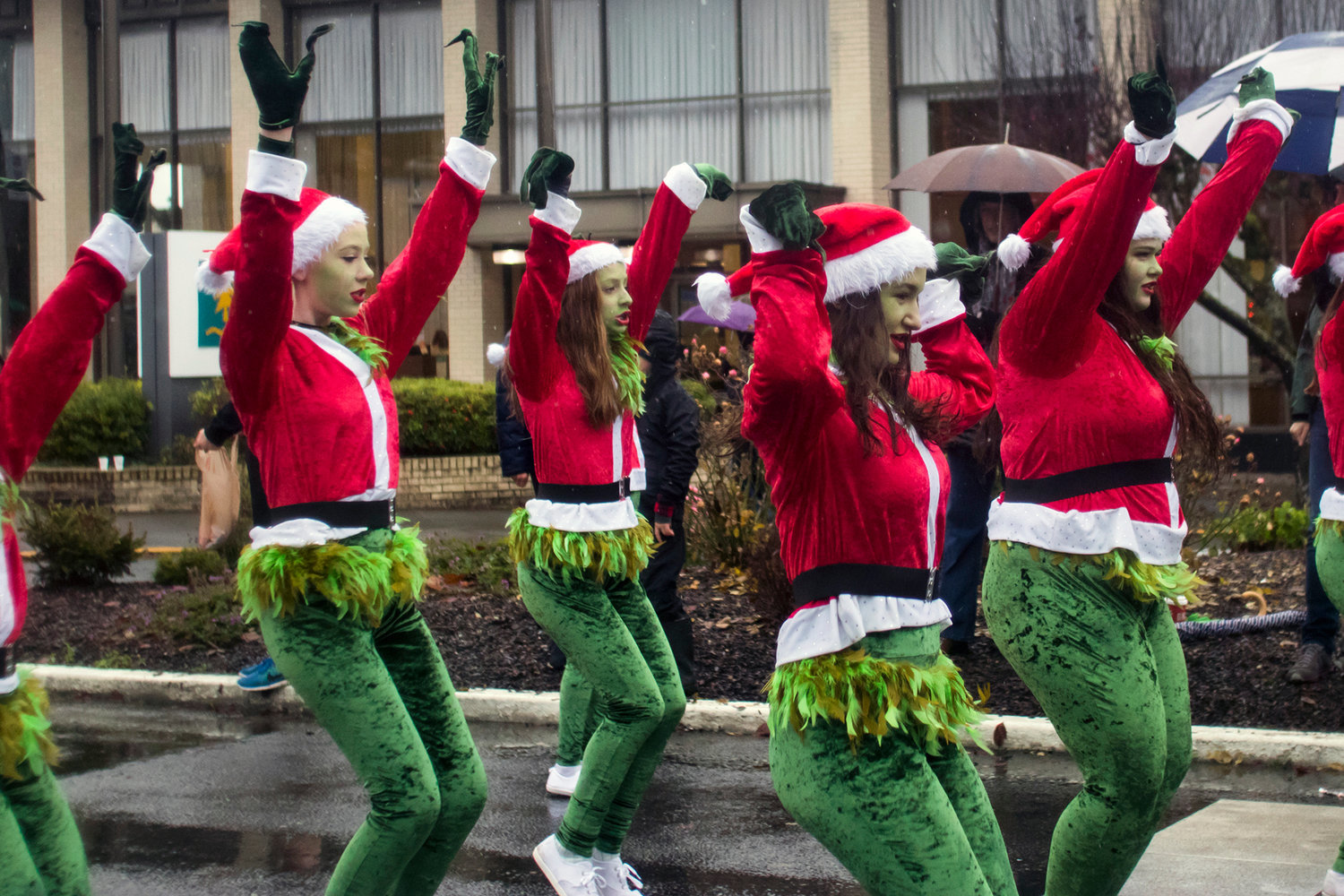 Girls dressed as the grinch dance along to music during the annual Santa Parade in downtown Chehalis in 2019.