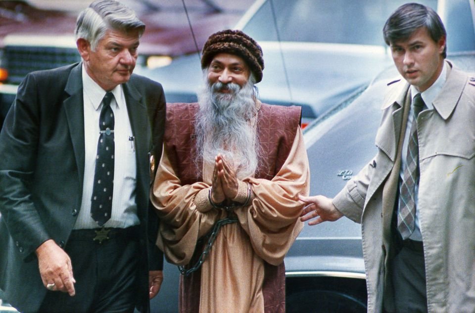 Federal marshals escort Bhagwan Shree Rajneesh to a bail hearing in Charlotte, N.C., in November, 1985 following his arrest while attempting to leave the country. He was indicted on federal immigration charges. Brent Wojahn/The Oregonian