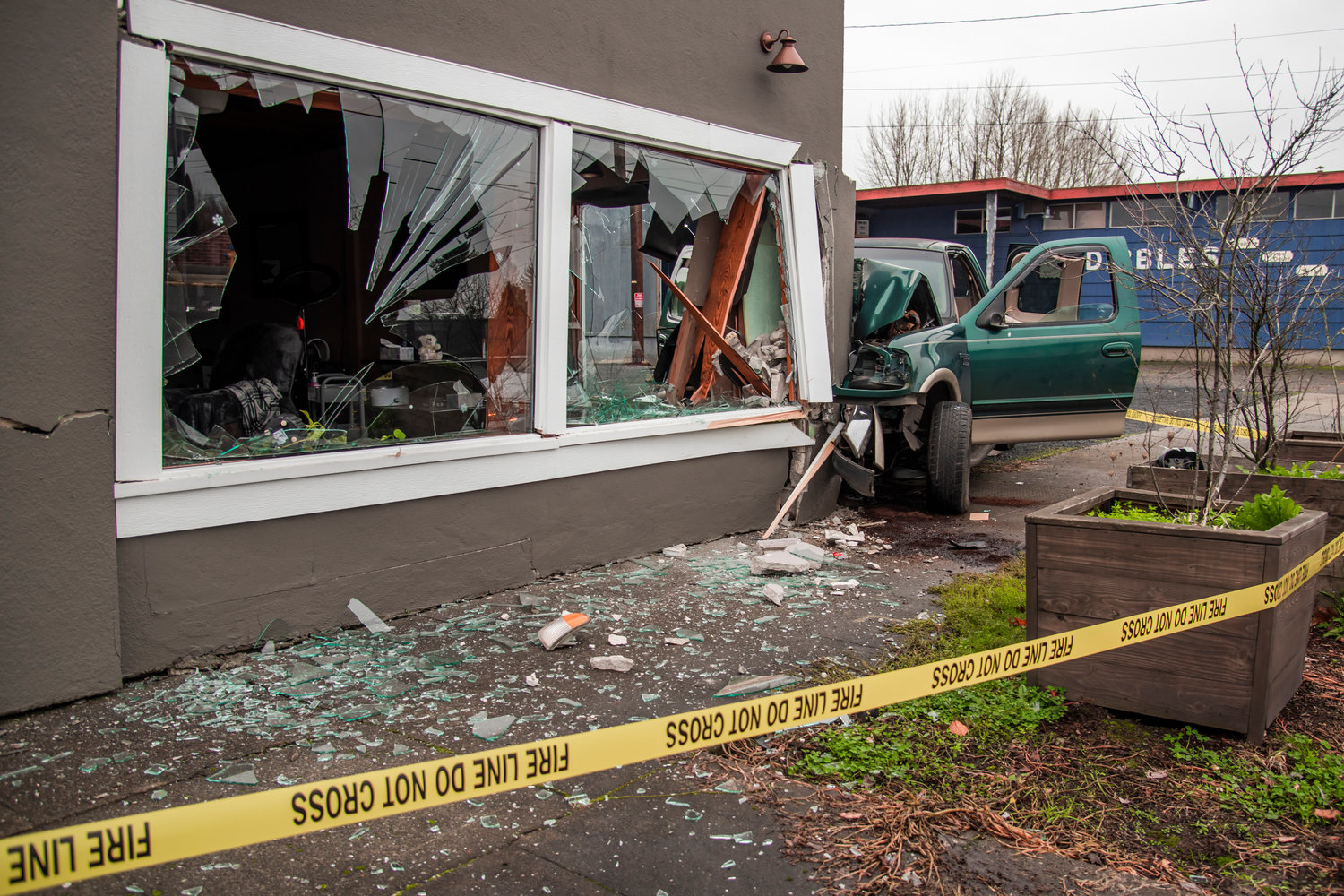 Shards of glass are seen scattered across the sidewalk in the 300 Block of South Tower Avenue in Centralia after a truck drove into the Lash and Brow Company Building Saturday morning.