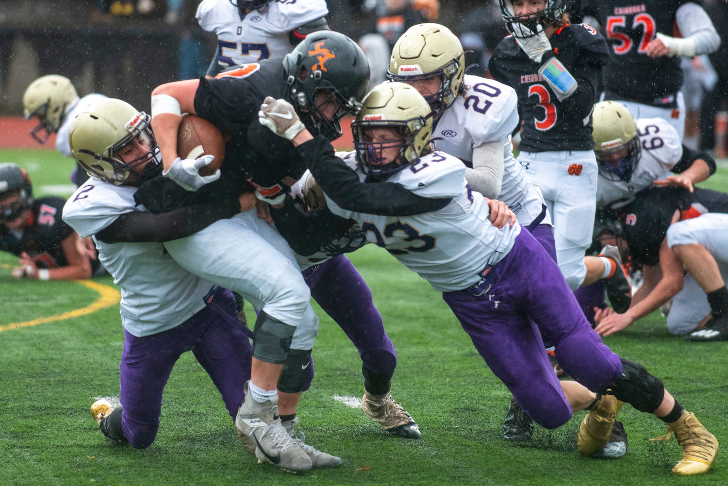 A group of Loggers tackle a Kalama player during the 2B state semifinals on Nov. 27.