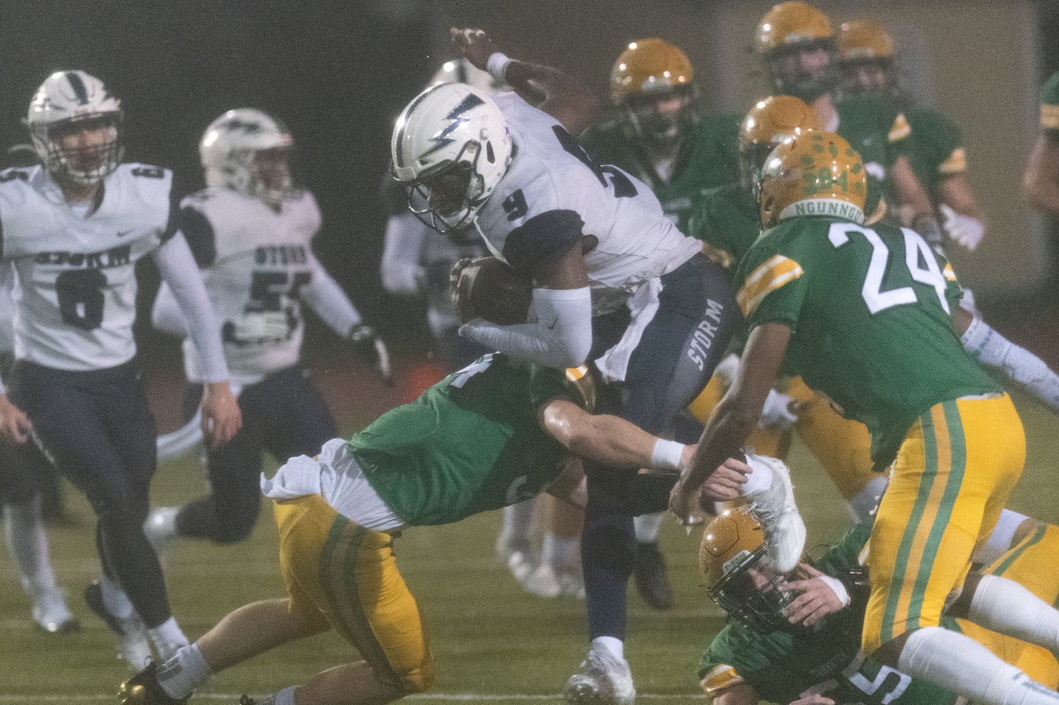 Squalicum's tailback attempts to hurdle past Tumwater defenders in the 2A state semifinals Nov. 27.