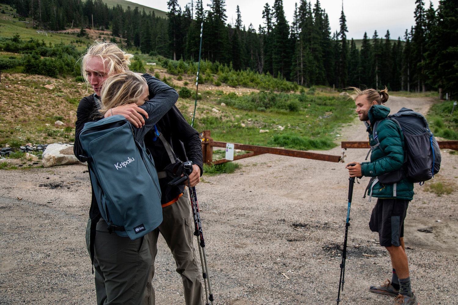 Jackson Parell of Florida with Sammy Potter of Maine, right, hugs his mom Nora Parell as they leave the Berthoud Pass trailhead to continue north on the Continental Divide Trail on Aug. 6, 2021, in Idaho, Colorado. Parell's mom visited the hikers to bring them food and lend them moral support along their journey. (Gina Ferazzi/Los Angeles Times/TNS)