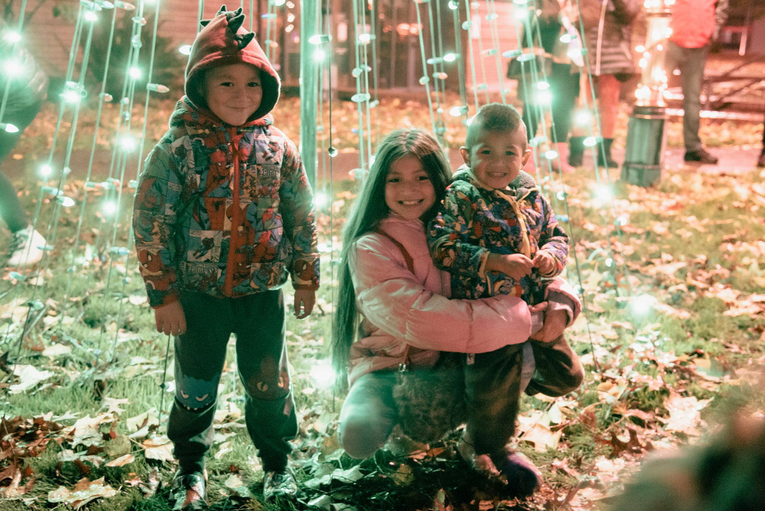 Members of the Villalba family pose for a photo with Christmas lights during a tree lighting ceremony in George Washington Park Friday night.