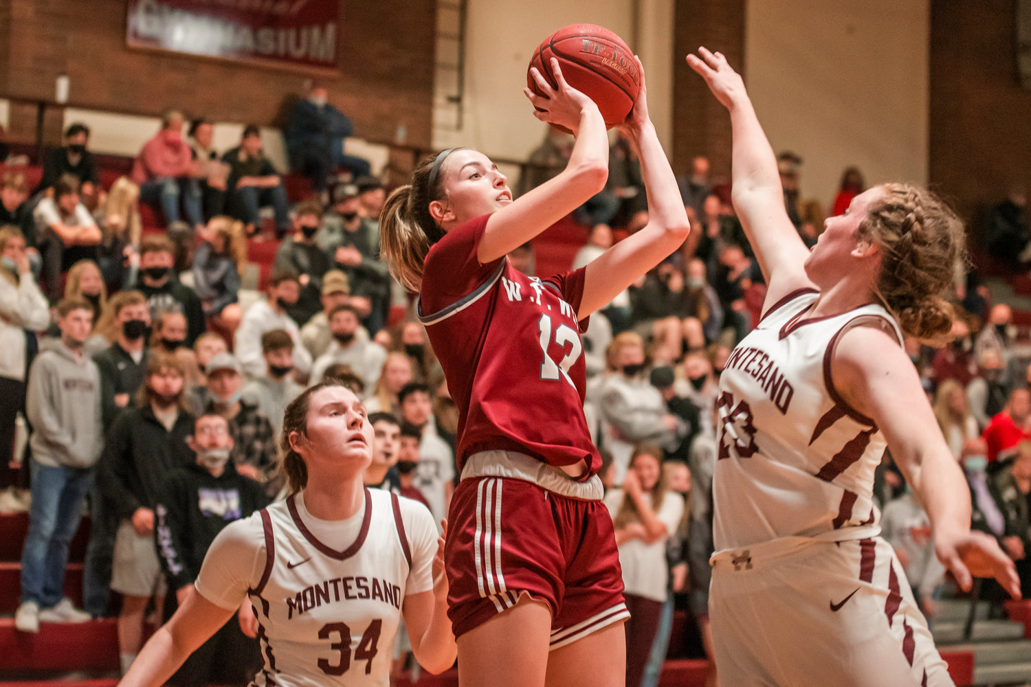 W.F. West’s Drea Brumfield (13) puts up a shot over Bulldog defenders in Montesano Tuesday night.