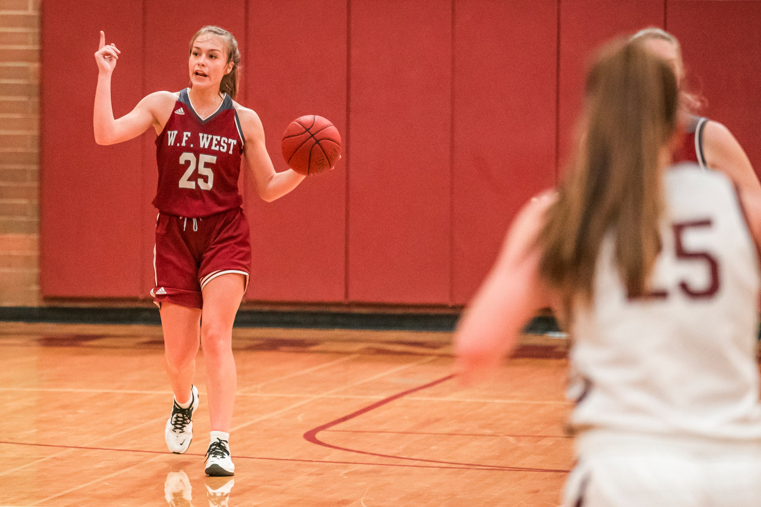 W.F. West’s Kyla McCallum (25) takes the ball up court during a game against Montesano Tuesday night.