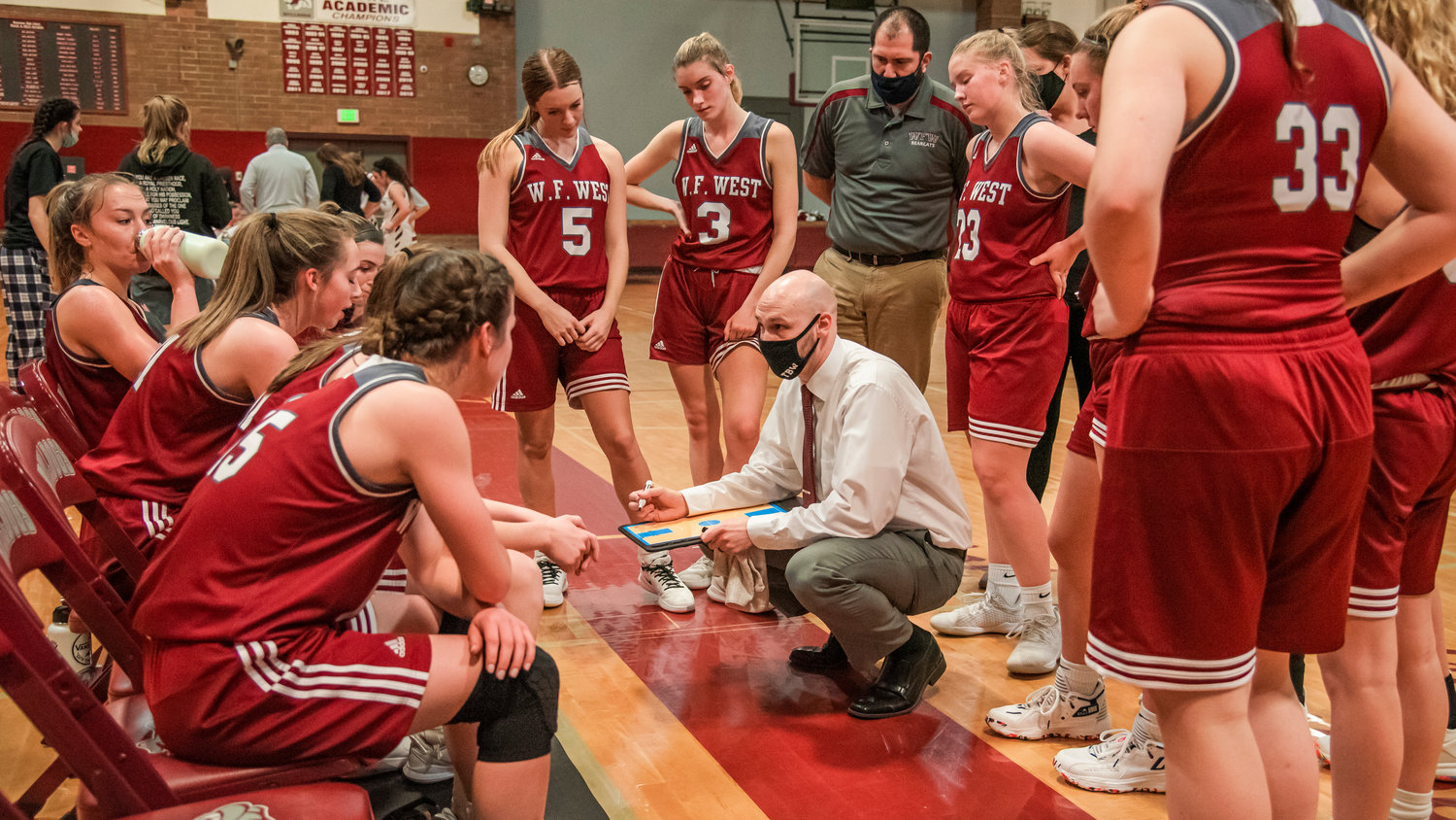 Head Coach Kyle Karnofski talks to players during a timeout in Montesano Tuesday night.