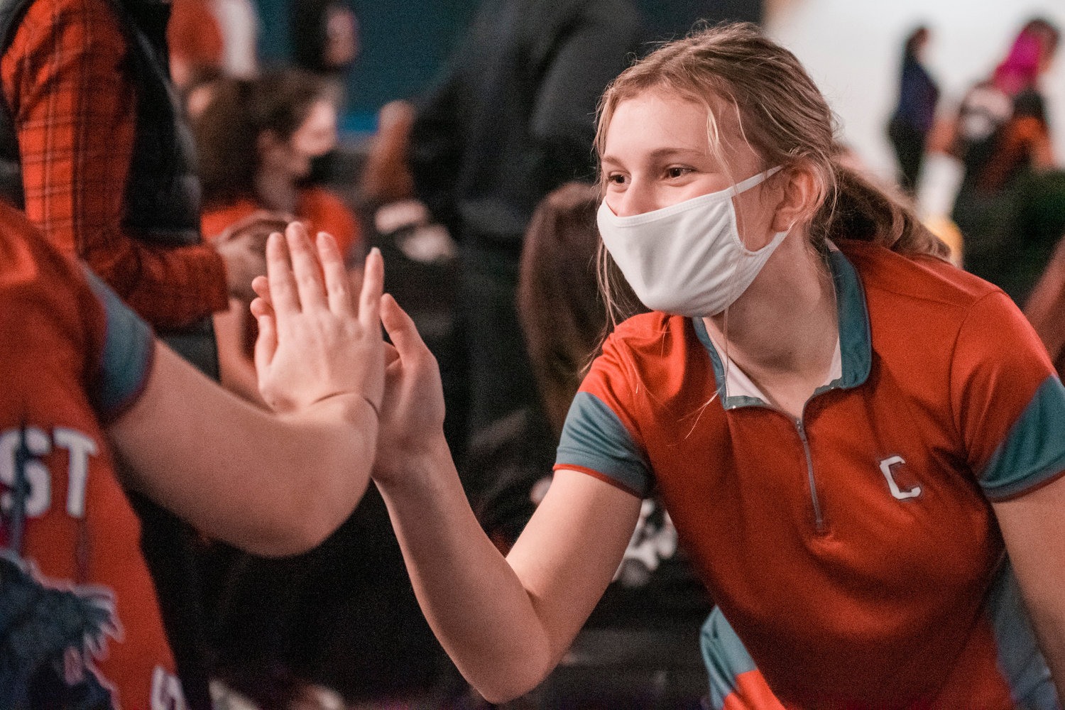 W.F. West’s Codi Bieker rolls a strike and receives high-fives from fellow Bearcats Tuesday at Fairway Lanes.