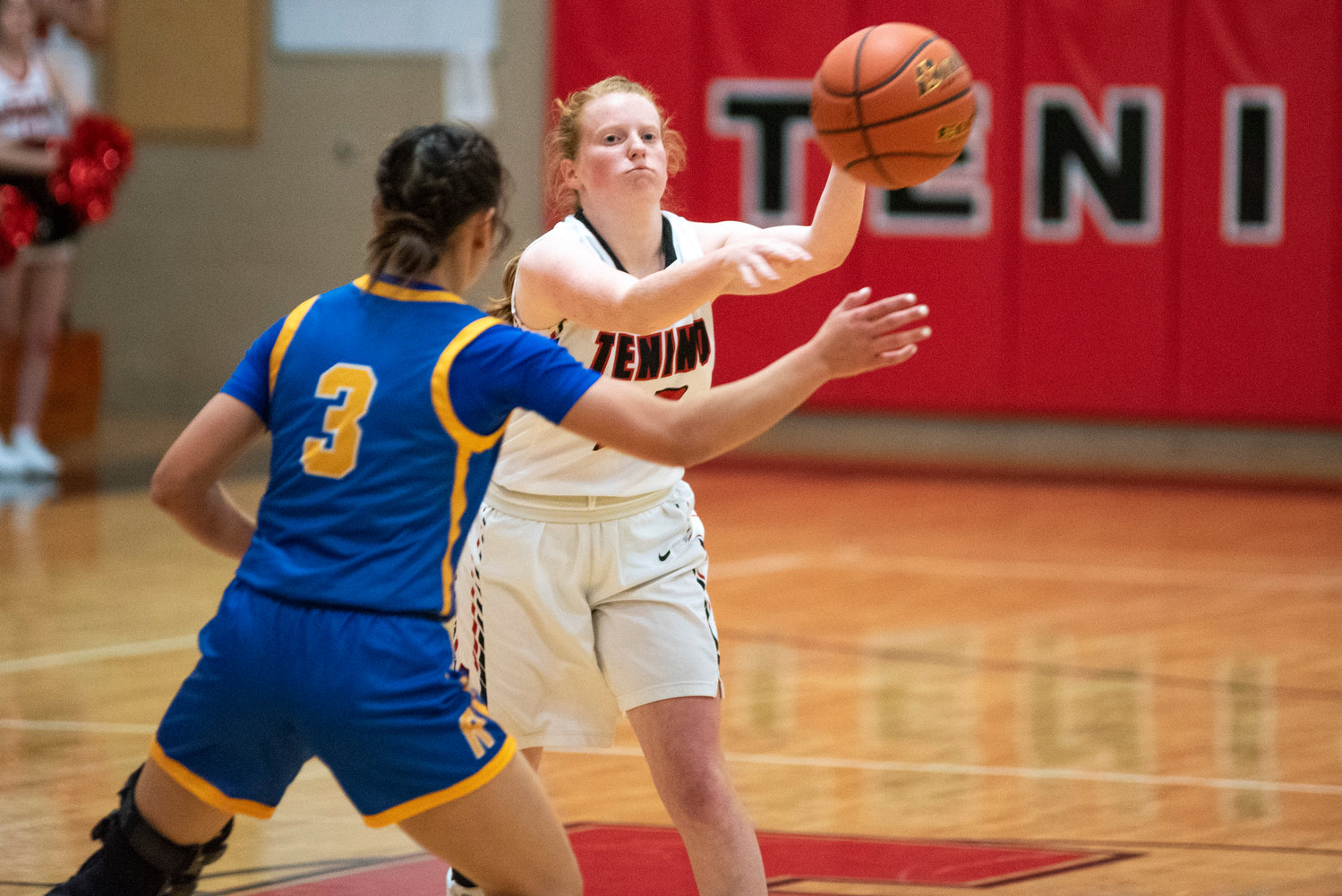 Tenino's Abby Severse (12) dishes off a pass against Rochester's Sadie Knutson (3) on Dec. 2.