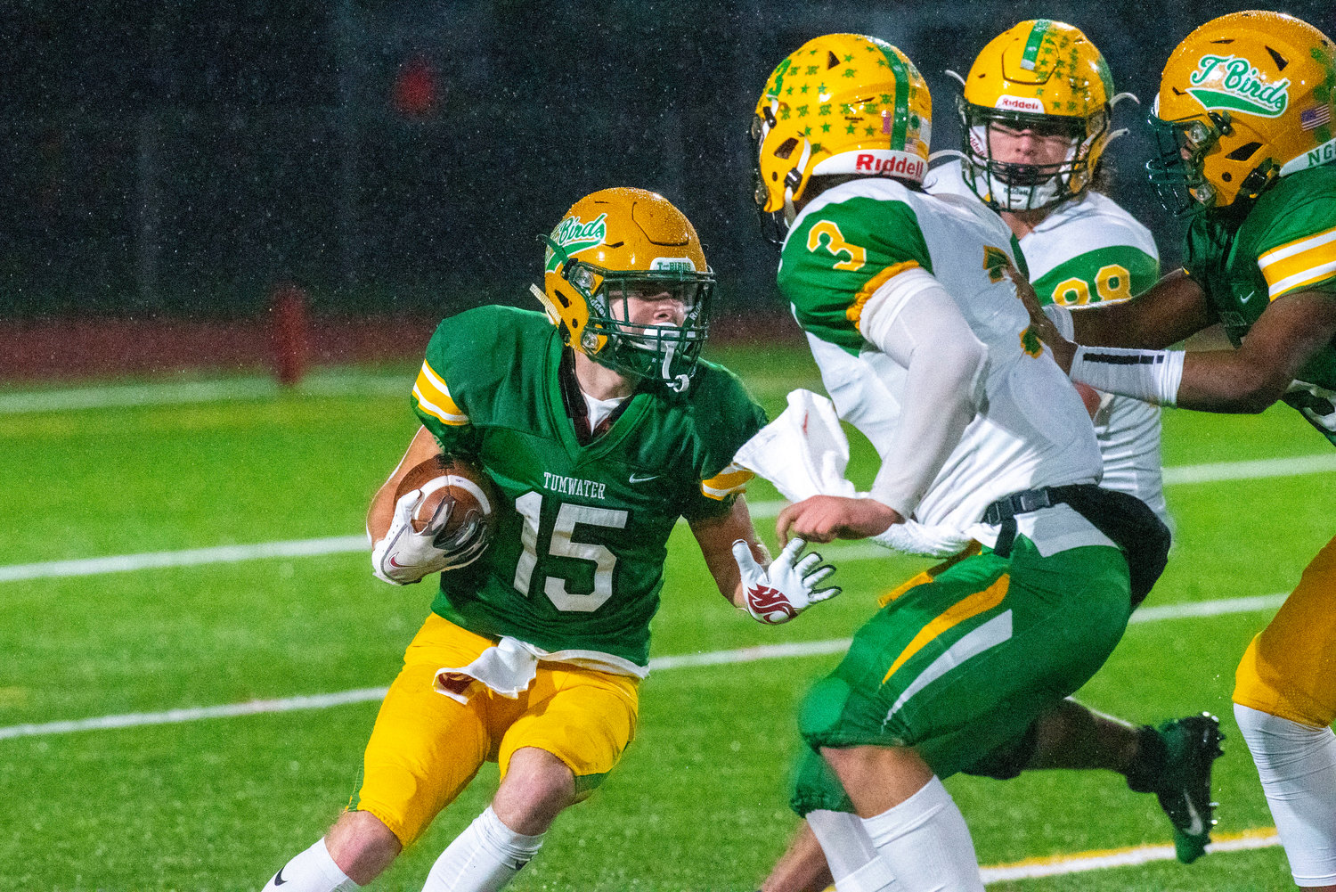 Tumwater’s Ashton Paine (15) looks for a seam while rushing against Lynden in the 2A state title game on Dec. 4.