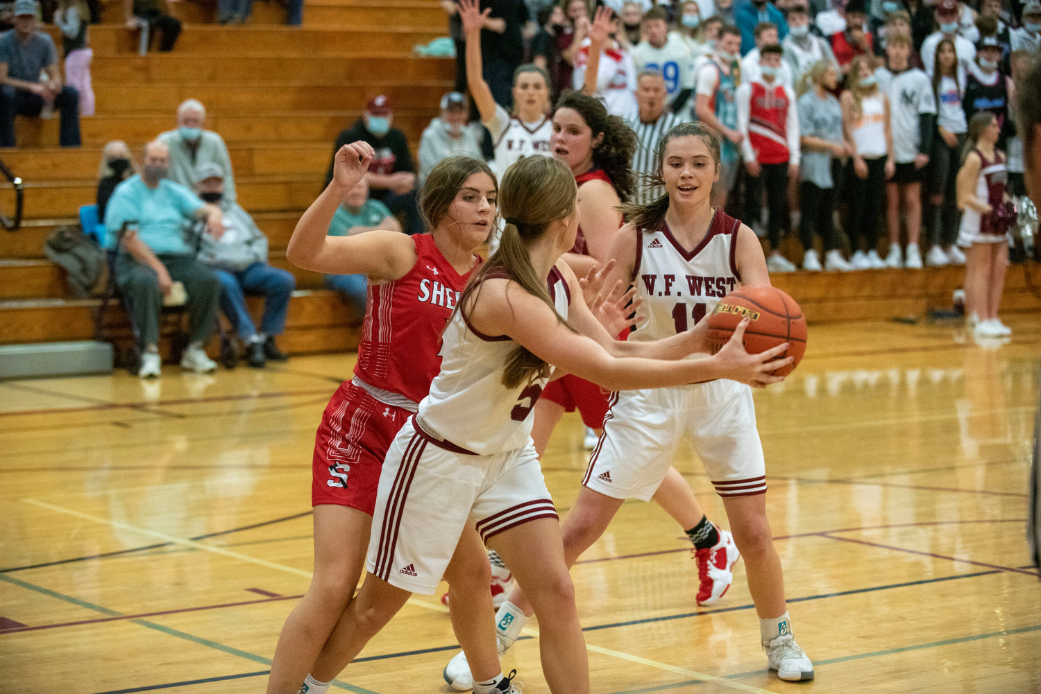 W.F. West's Mak Mencke (5) dishes off a pass to Olivia Remund (11) against Shelton on Dec. 7.