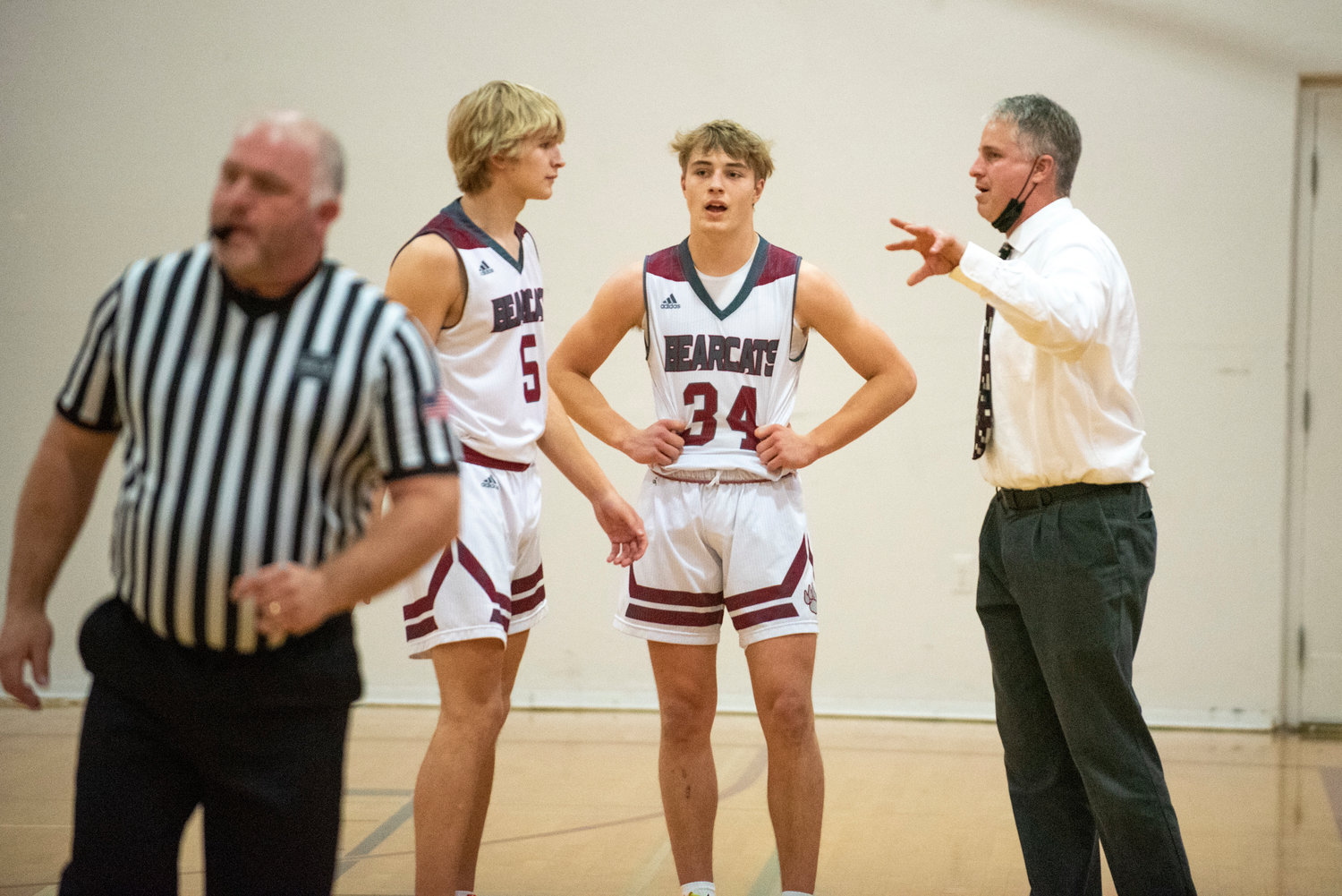 W.F. West coach Chris White, right, talks with Gage Brumfield (34) and Dirk Plakinger during free throws against Shelton on Dec. 8.