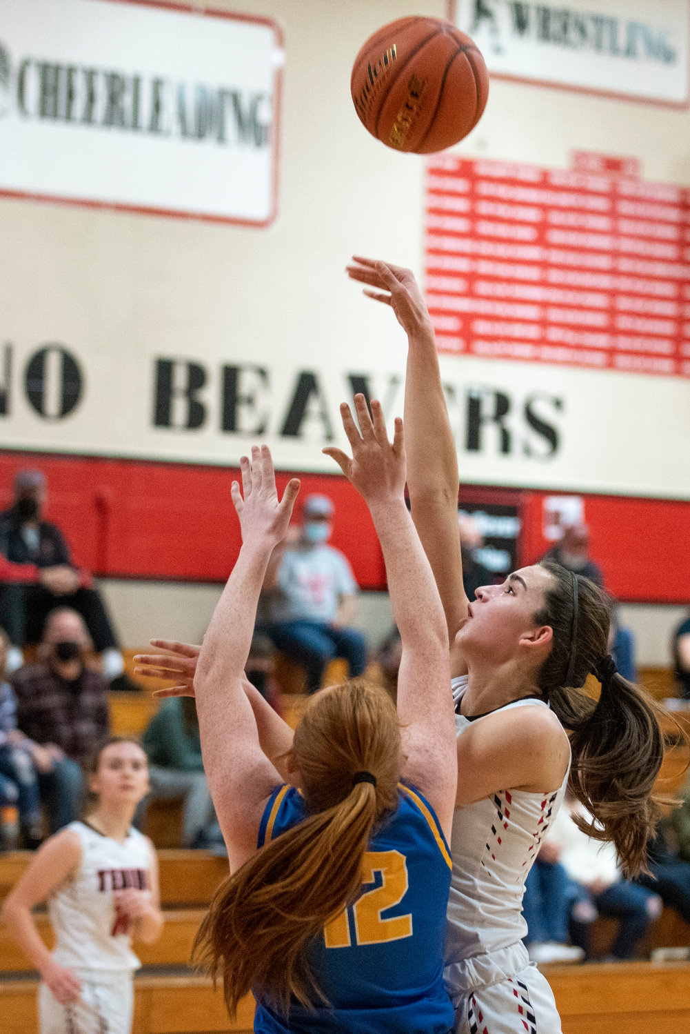Tenino's Ashley Schow throws up a shot against Adna's Natalie Loose (12) on Dec. 14.
