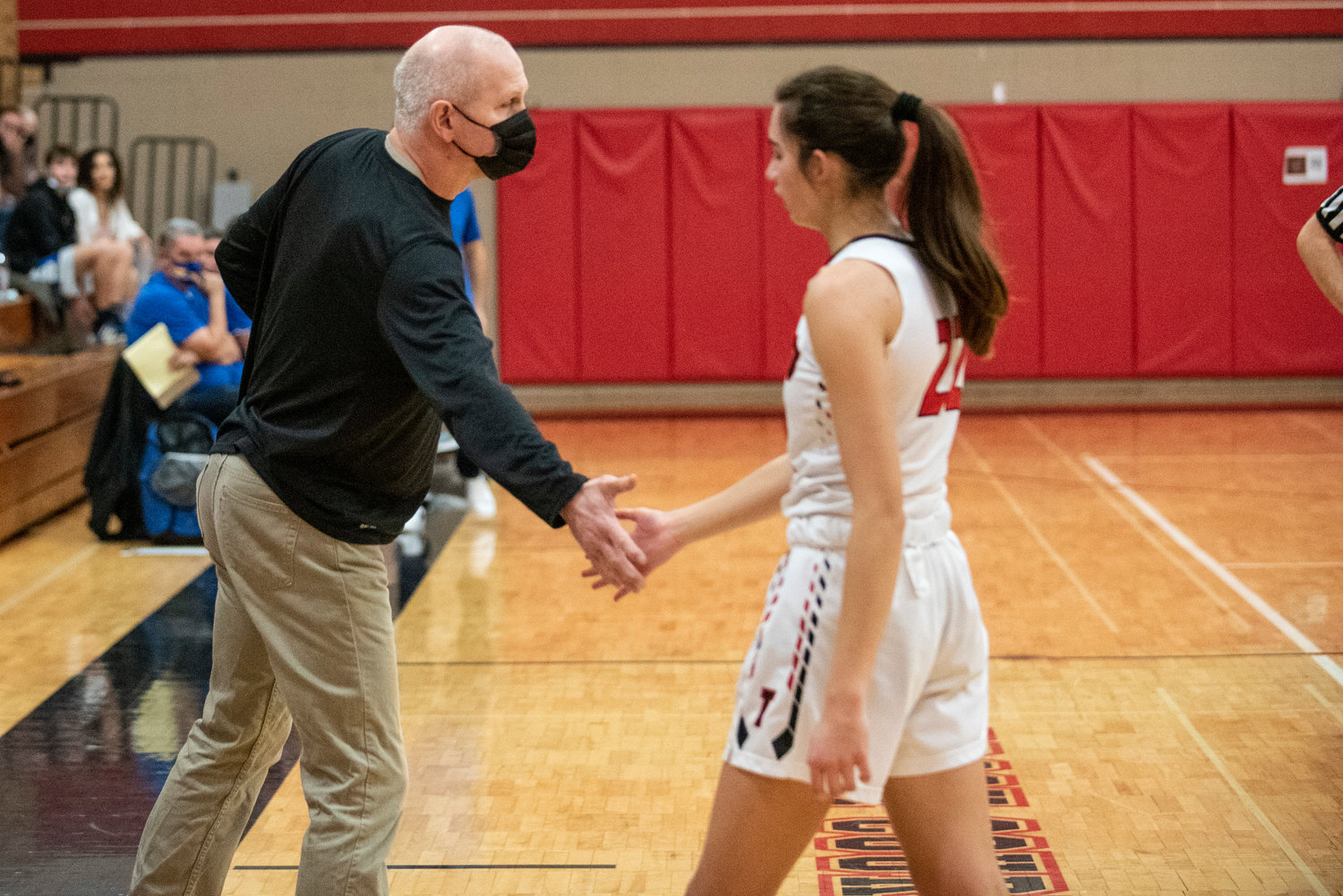 Tenino coach Scott Ashmore high-fives Ashley Schow during a home game against Adna on Dec. 14.
