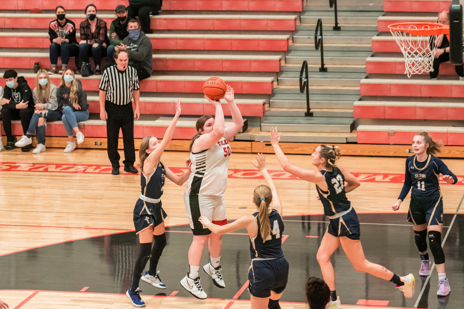Toledo’s Taylor Langhaim (50) looks to shoot over Seton Catholic defenders during a game Saturday night.