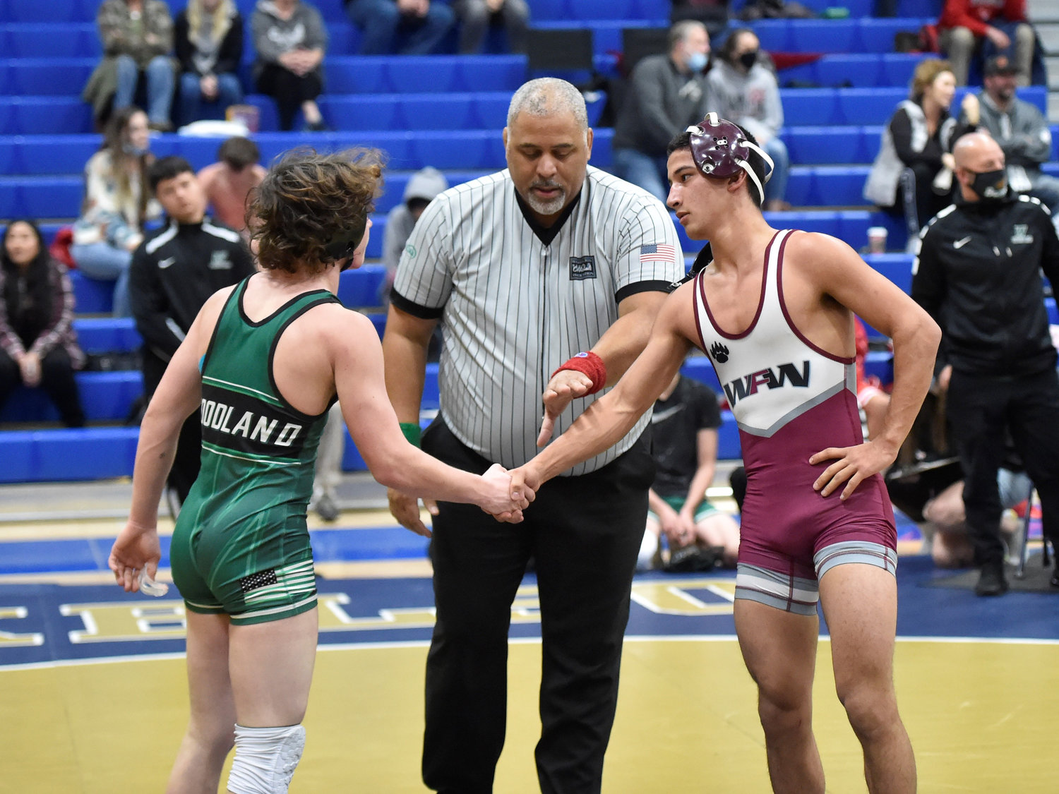 W.F. West’s Bo Davis shakes hand with a Woodland wrestler after beating him by decision on Wednesday, Dec. 8, at Kelso High School.