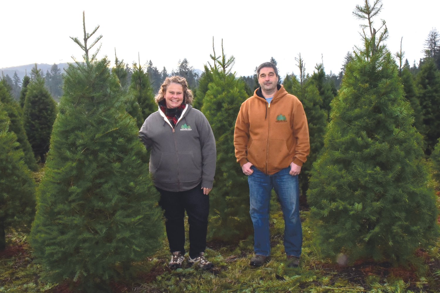Shelley and Darren Sprouffske show off the Douglas firs they grew on their tree farm, Sprouffske Trees, Inc. The farm has been in the family since the 60s, and has been worked on by four Sprouffske generations, a family that's been in Rainier for 101 years.